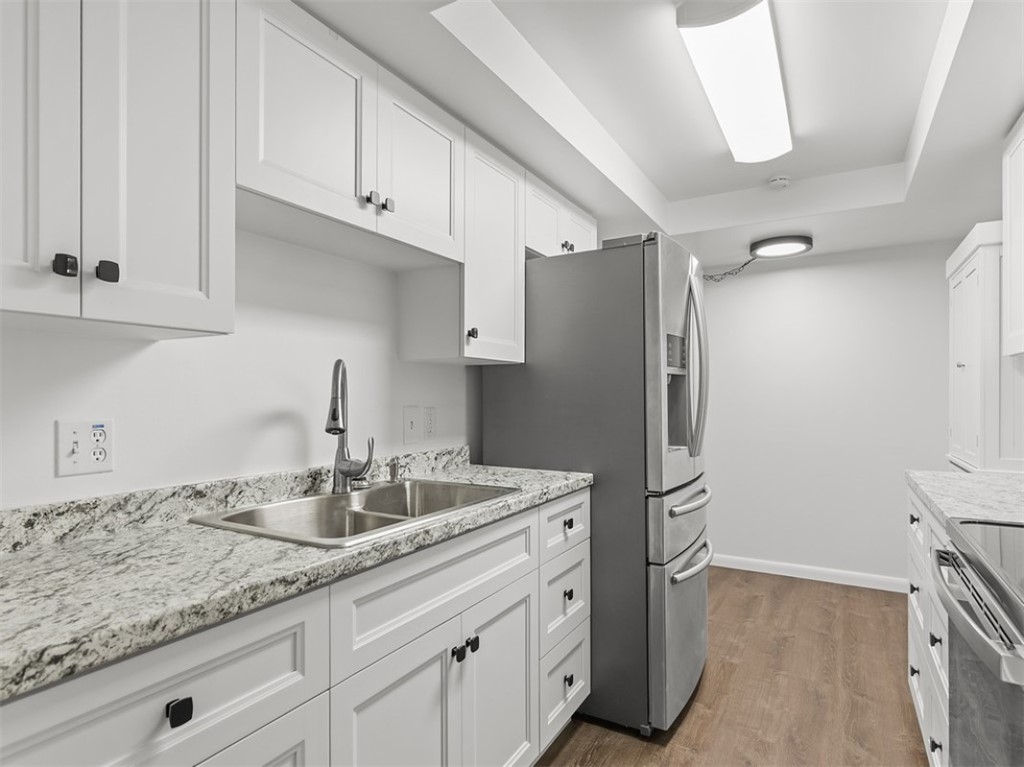 1166 6th Avenue, Unit C5 Vero Beach, FL 32960 - Photo 13 of 34 a kitchen with stainless steel appliances granite countertop a sink and refrigerator