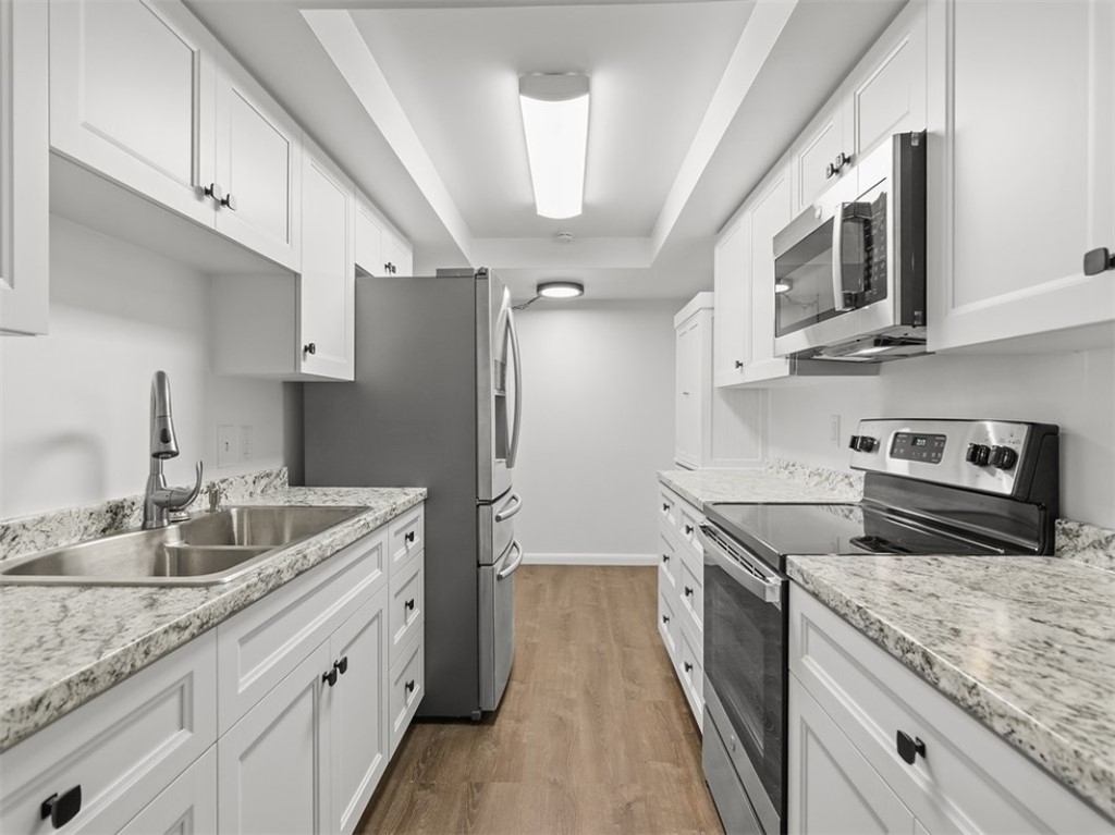 1166 6th Avenue, Unit C5 Vero Beach, FL 32960 - Photo 16 of 34 a kitchen with stainless steel appliances granite countertop a sink stove and refrigerator