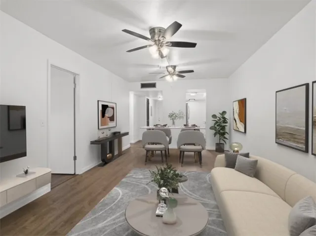 a living room with furniture kitchen view and a flat screen tv
