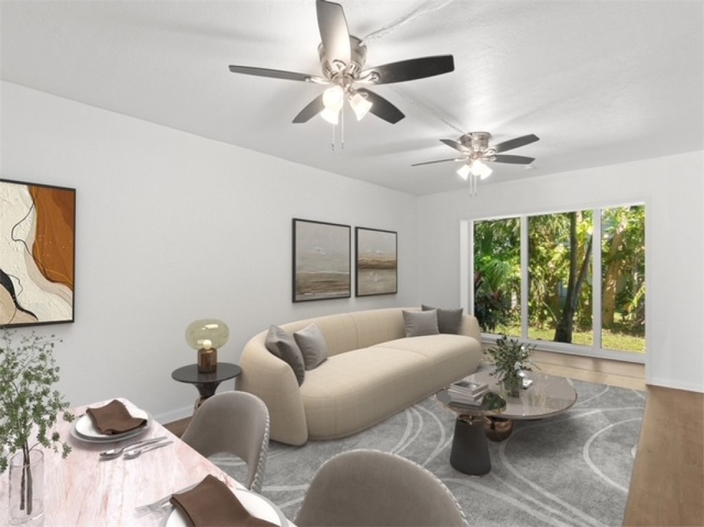 1166 6th Avenue, Unit C5 Vero Beach, FL 32960 - Photo 3 of 34 a living room with furniture and a large window