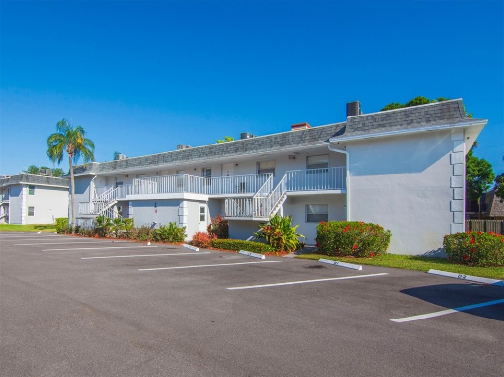 1166 6th Avenue, Unit C5 Vero Beach, FL 32960 - Photo 31 of 34 a front view of a building with yellow lighting