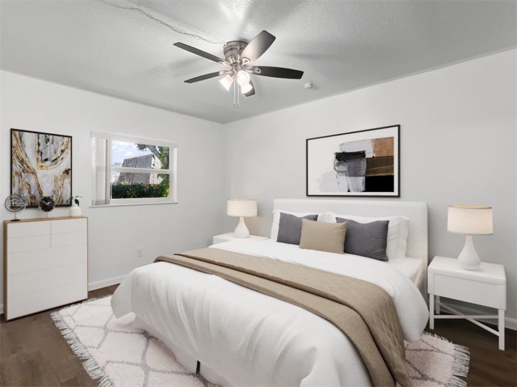 1166 6th Avenue, Unit C5 Vero Beach, FL 32960 - Photo 6 of 34 a bedroom with a large bed and a chandelier