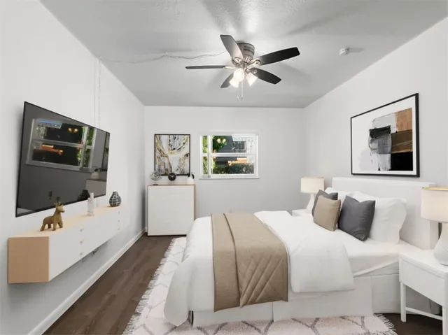 a bedroom with a large bed and a flat screen tv