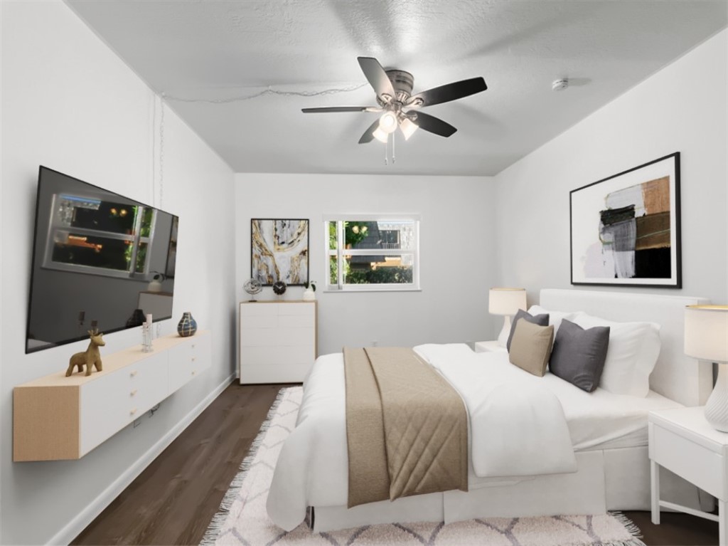 1166 6th Avenue, Unit C5 Vero Beach, FL 32960 - Photo 7 of 34 a bedroom with a large bed and a flat screen tv