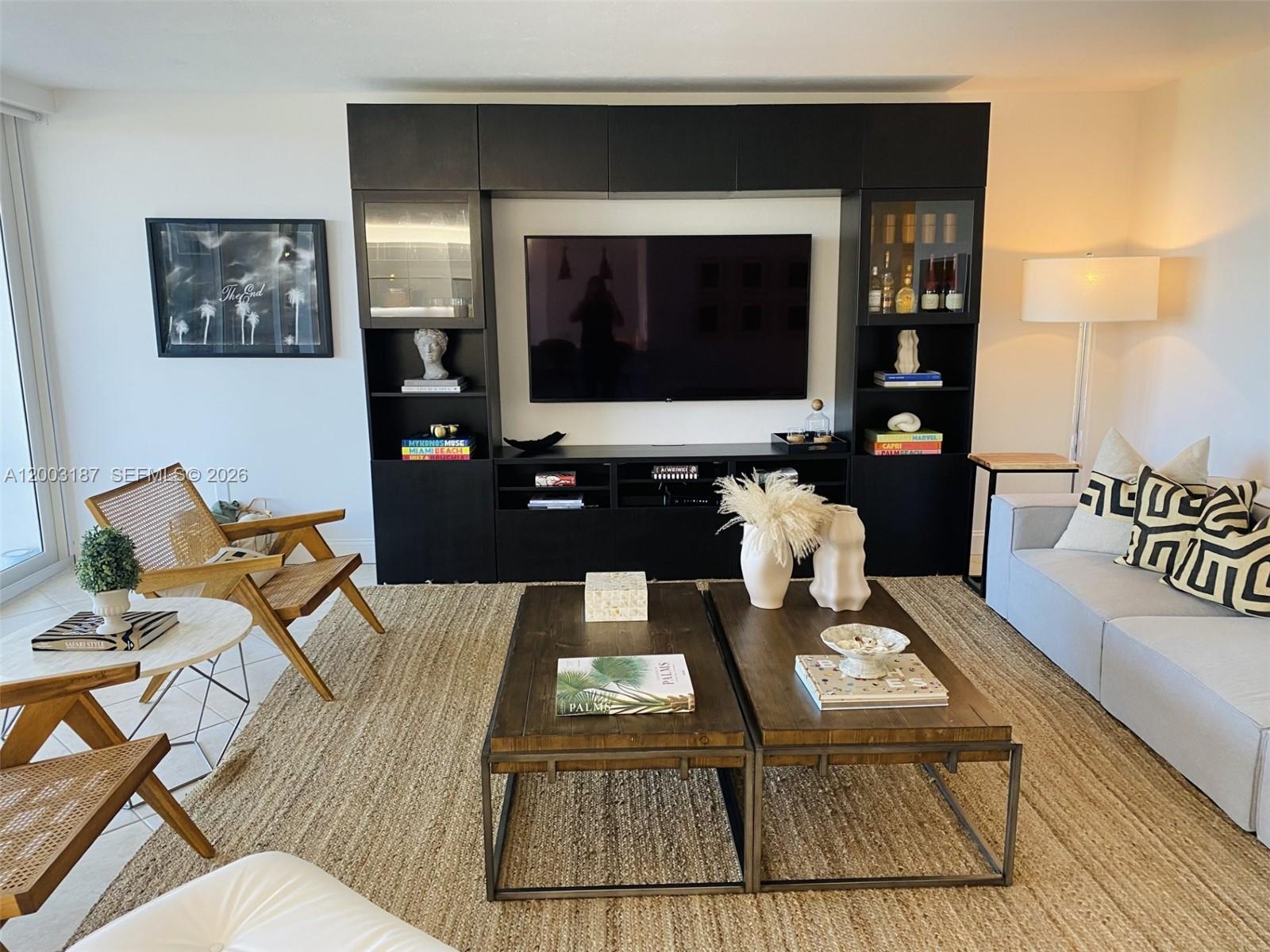 881 Ocean Drive, Unit 3E Key Biscayne, FL 33149 - Photo 12 of 15 a living room with furniture and a fireplace