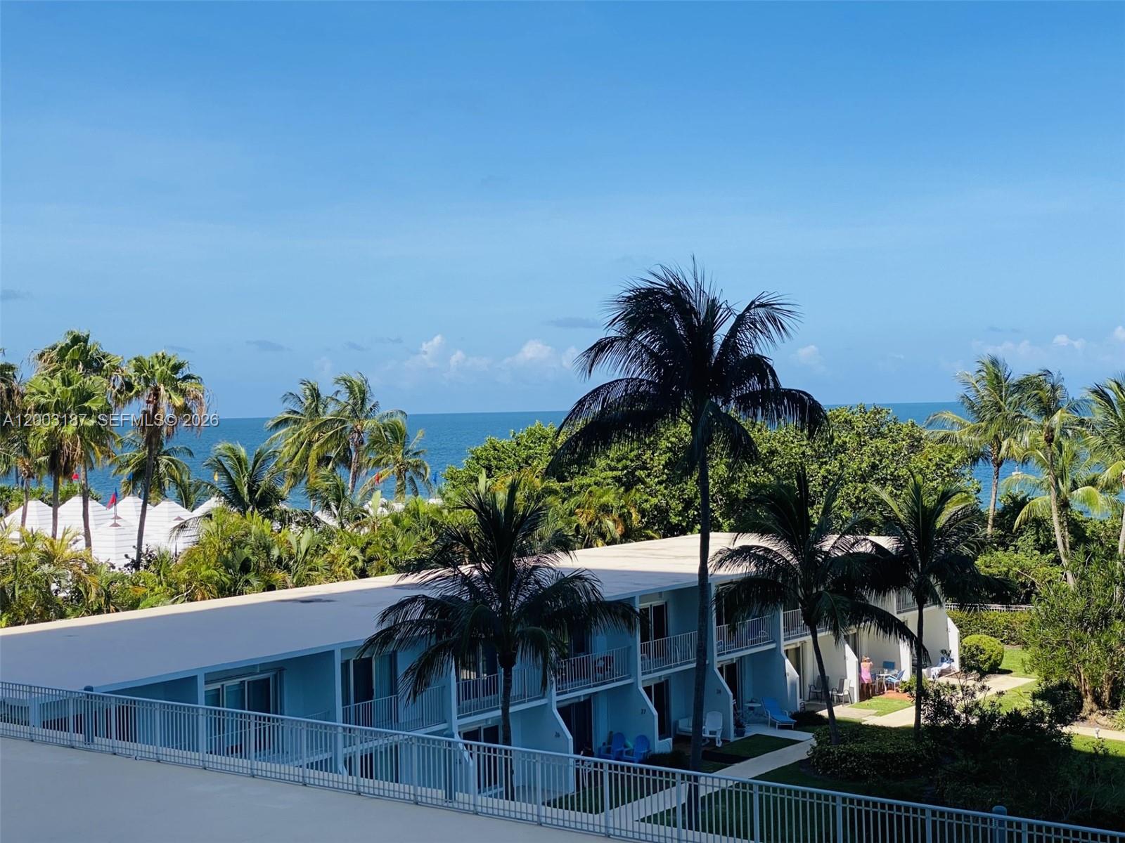 881 Ocean Drive, Unit 3E Key Biscayne, FL 33149 - Photo 3 of 15 a view of a house with a palm tree