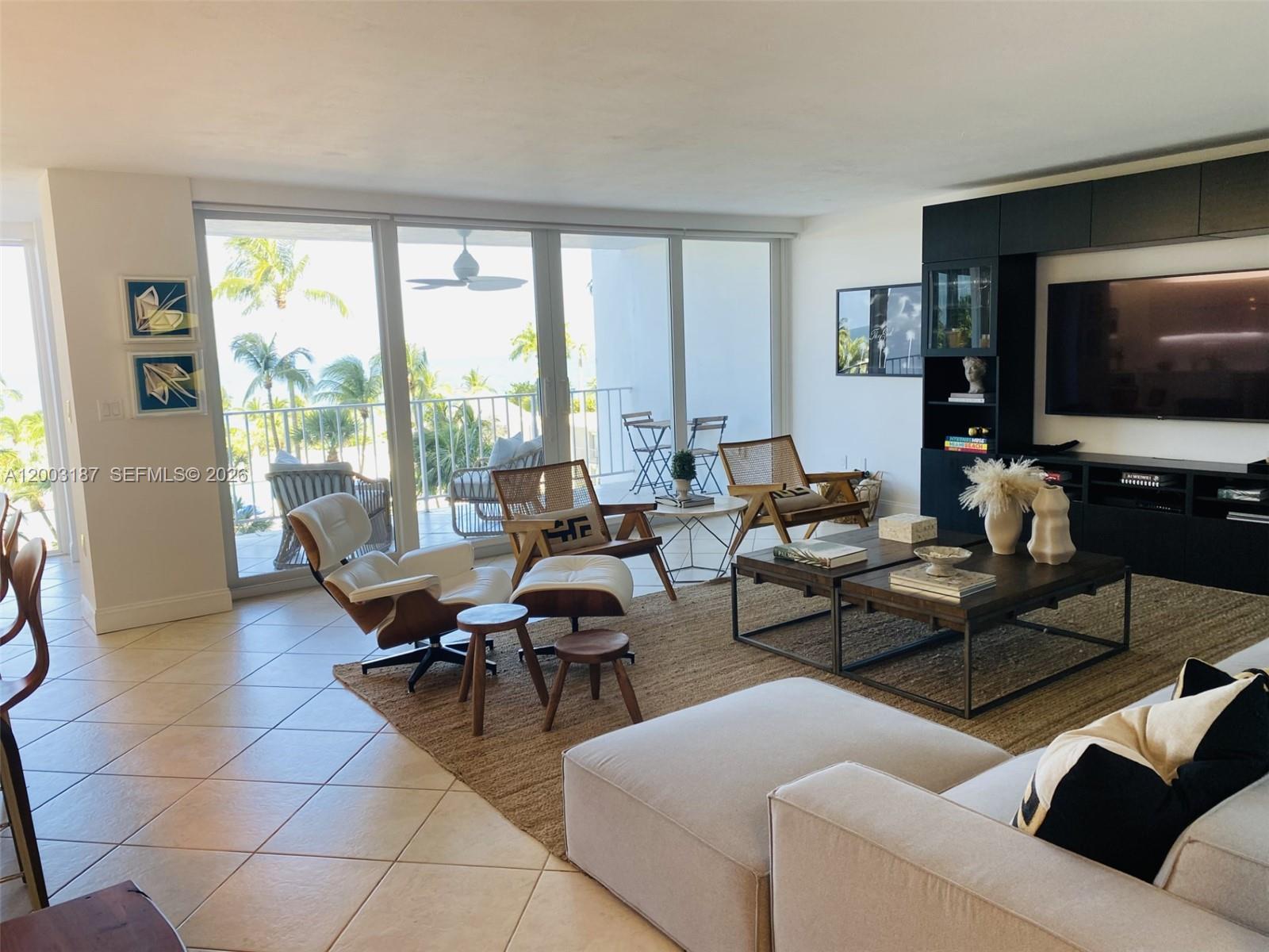 881 Ocean Drive, Unit 3E Key Biscayne, FL 33149 - Photo 8 of 15 a living room with furniture and a flat screen tv
