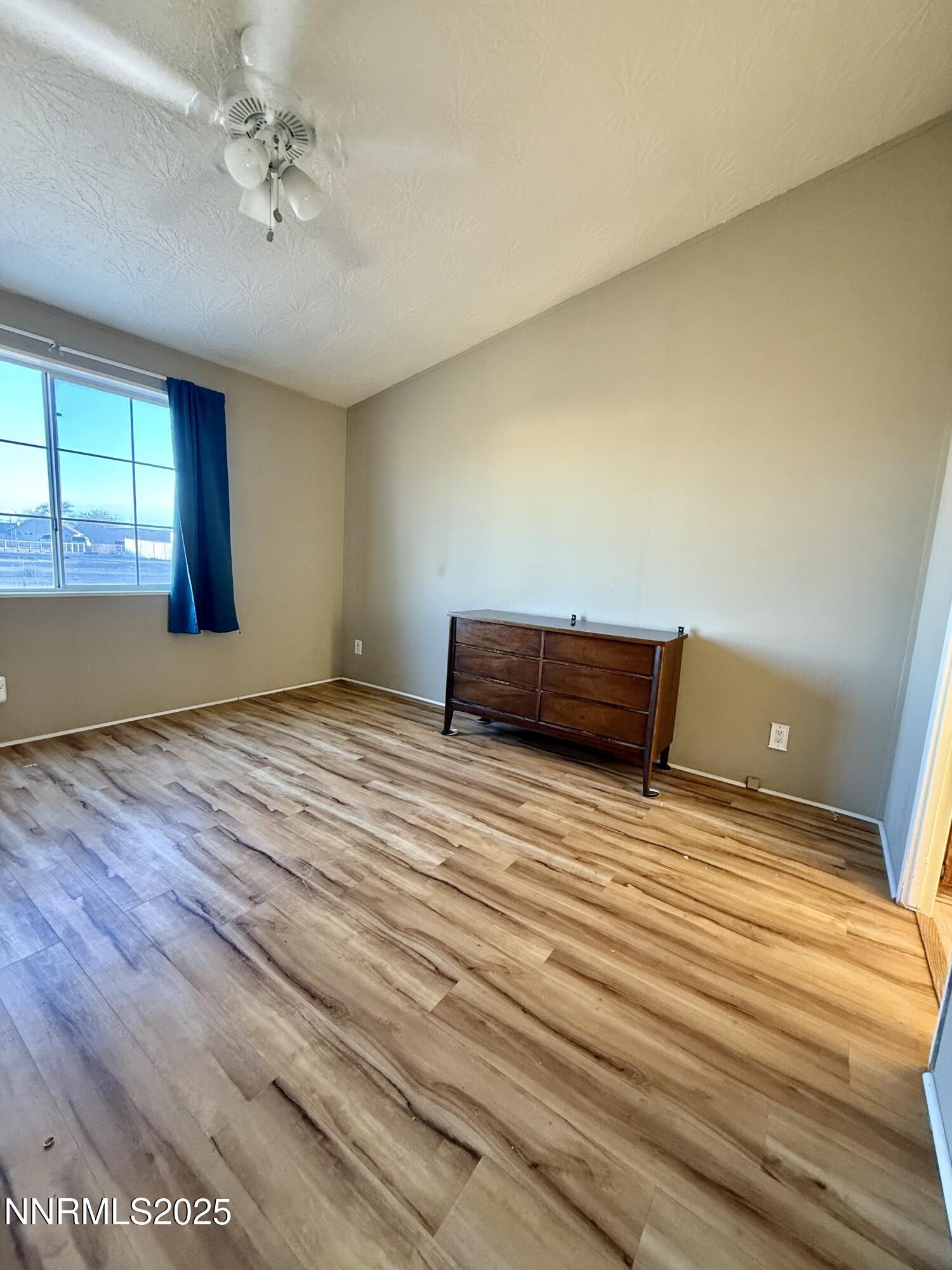 195 Classic Way Fallon, NV 89406 - Photo 7 of 10 a view of empty room with window and wooden floor