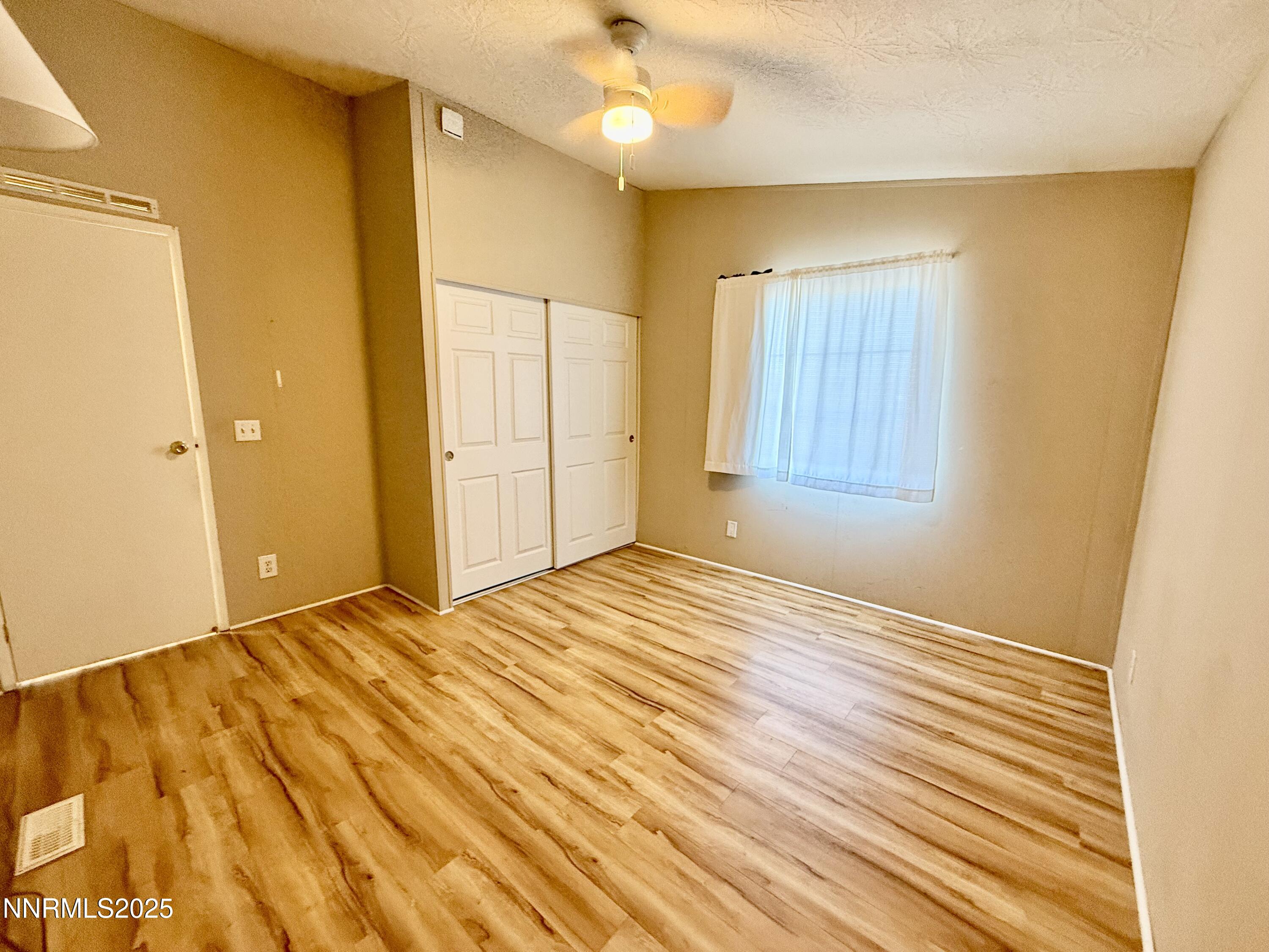 195 Classic Way Fallon, NV 89406 - Photo 8 of 10 a view of an empty room with wooden floor