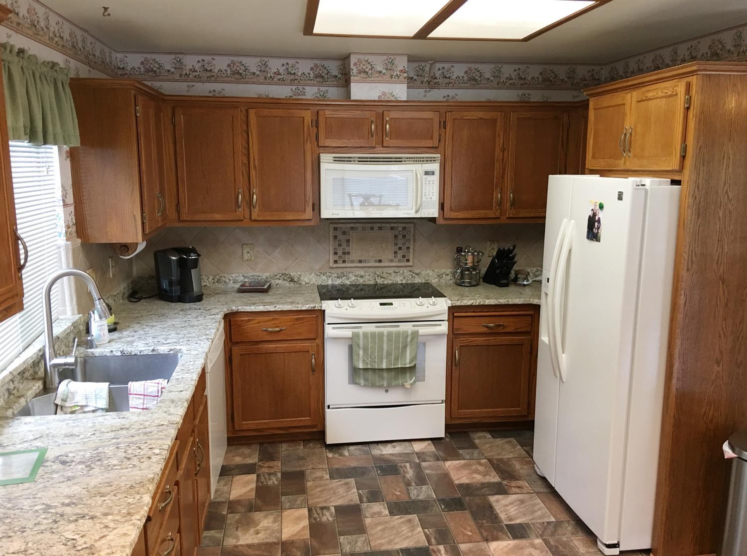 12221 Galice Road Merlin, OR 97532 - Photo 10 of 35 a kitchen with a refrigerator sink and cabinets