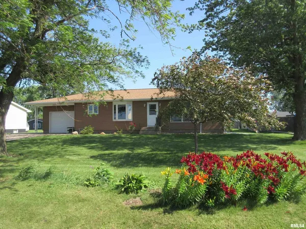 a view of a house with a big yard and potted plants