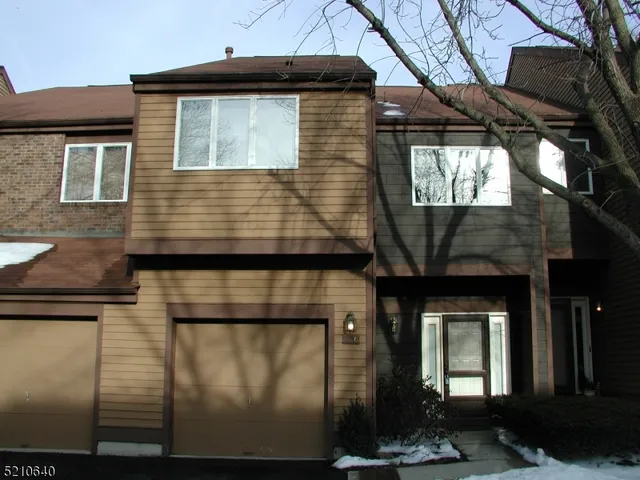 a front view of a house with garage