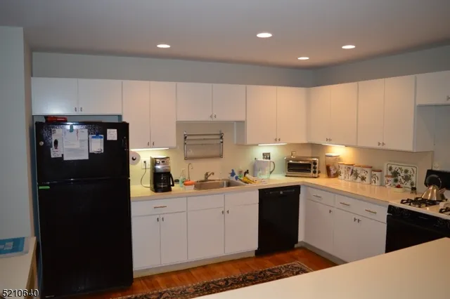 a kitchen with a sink a stove and cabinets