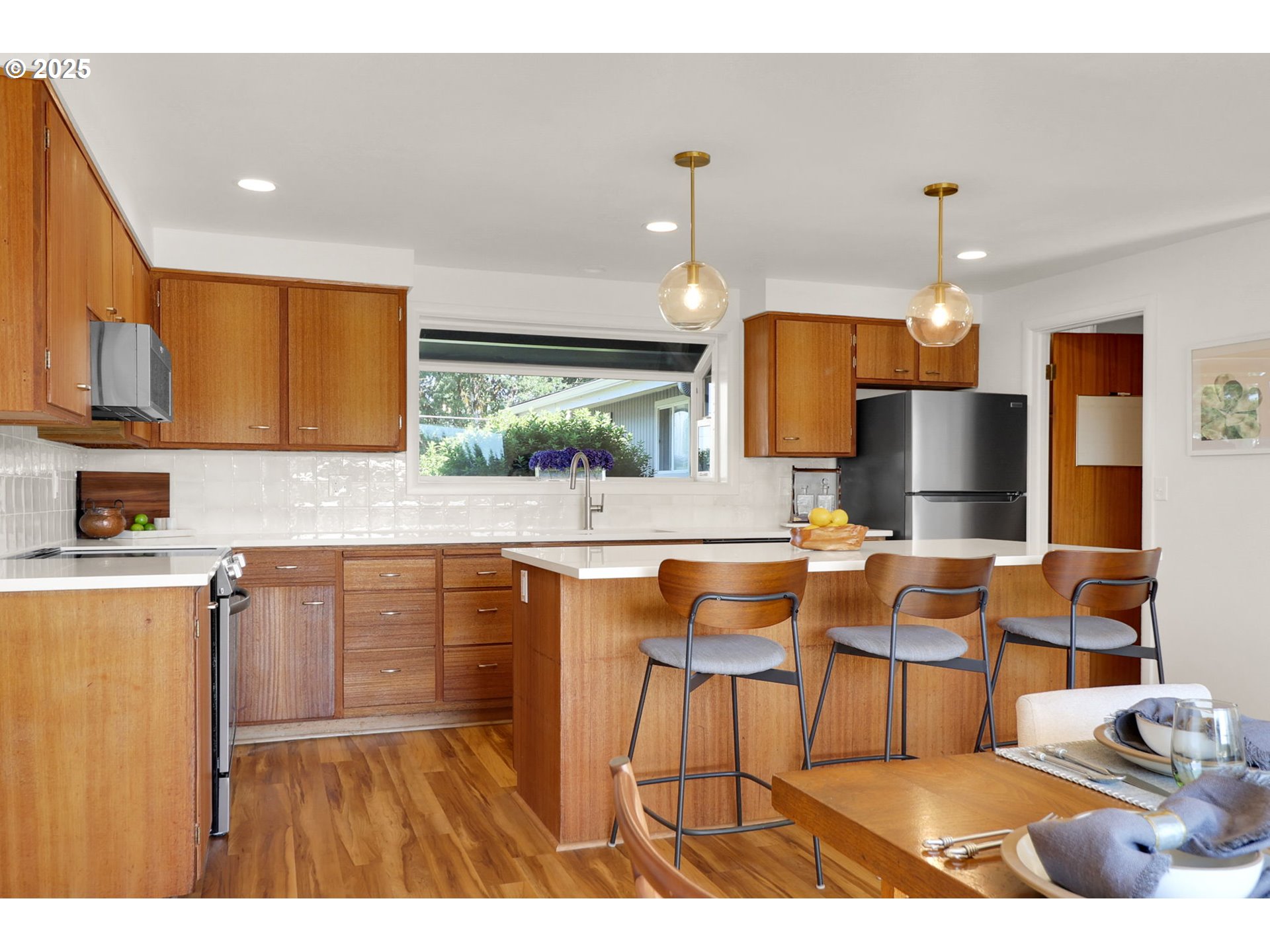 90774 Alvadore Road Junction City, OR 97448 - Photo 11 of 43 a kitchen with stainless steel appliances kitchen island granite countertop a table chairs in it and a microwave