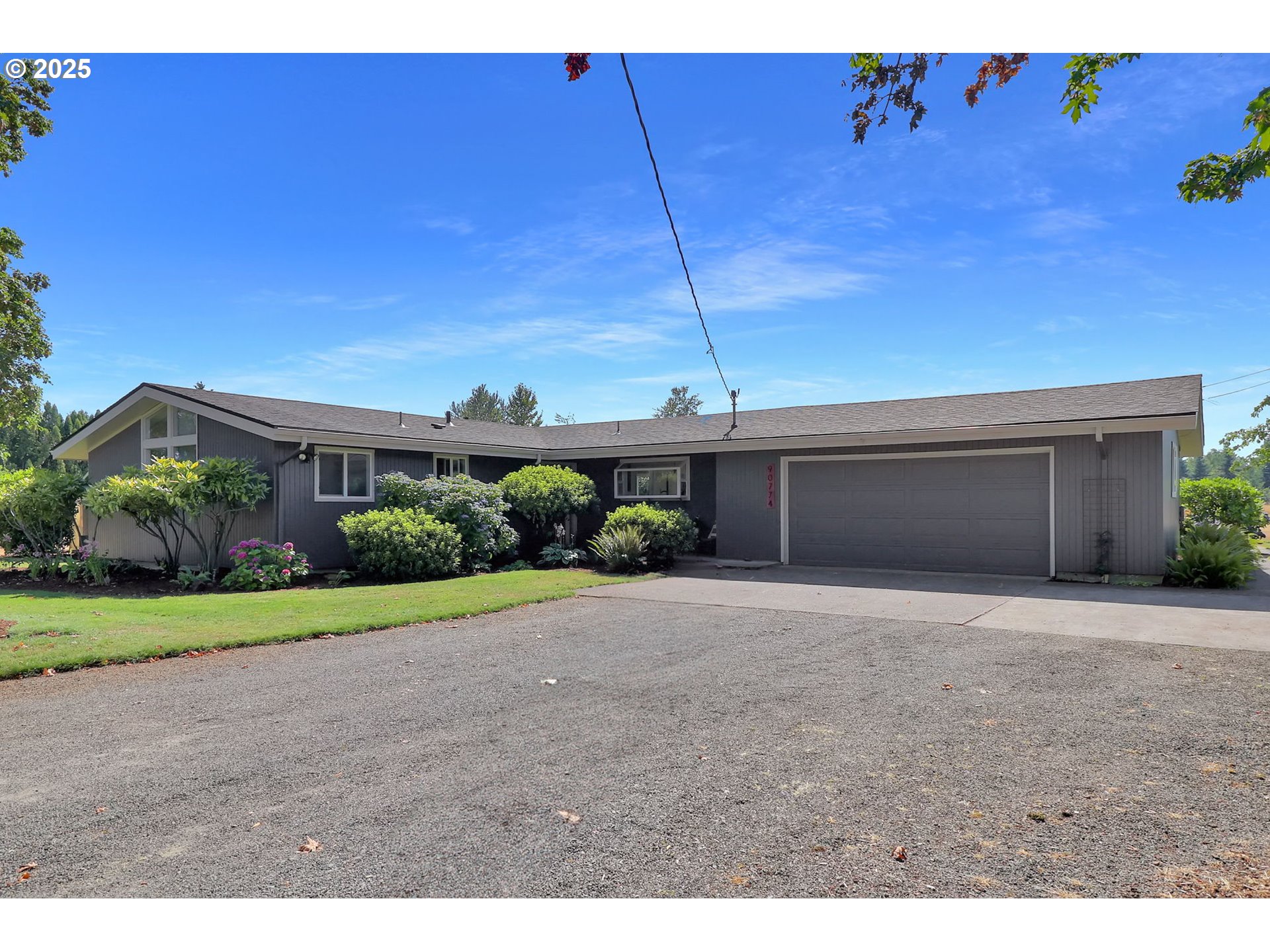 90774 Alvadore Road Junction City, OR 97448 - Photo 2 of 43 a front view of a house with a yard and garage