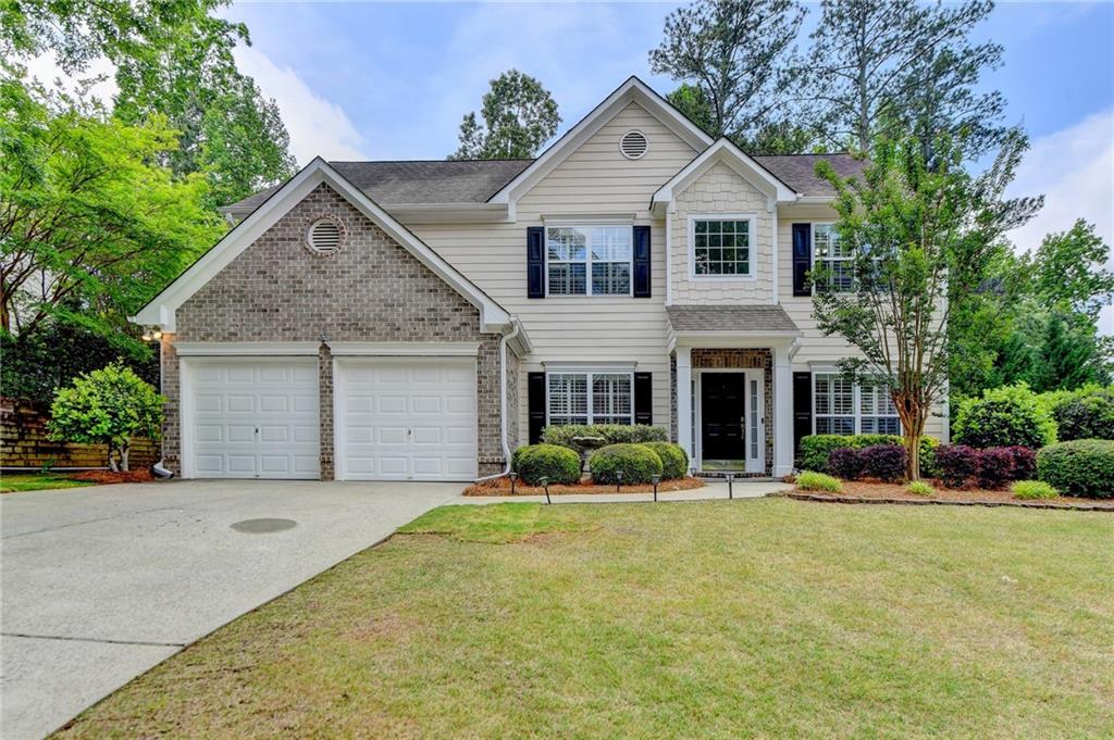 a front view of a house with a yard and garage
