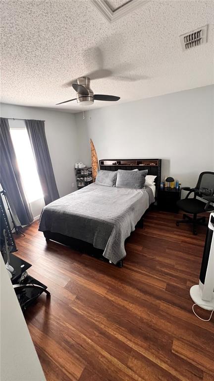11102 Upton Street Spring Hill, FL 34608 - Photo 11 of 23 a bedroom with a bed and wooden floor