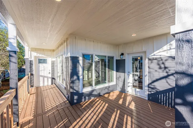 a view of a porch with wooden floor and iron stairs