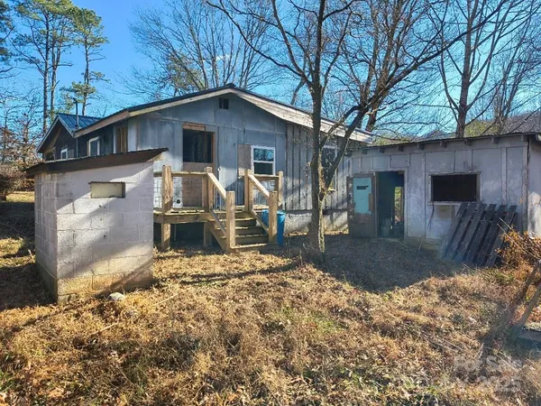 a front view of house with yard outdoor seating and barbeque oven