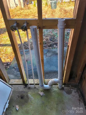 a view of an empty room with a floor to ceiling window