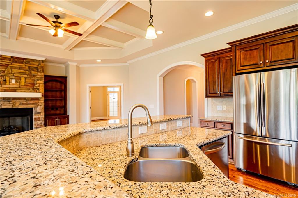 6631 Fox Ridge Circle Davidson, NC 28036 - Photo 14 of 48 a kitchen with stainless steel appliances granite countertop a sink stove and refrigerator