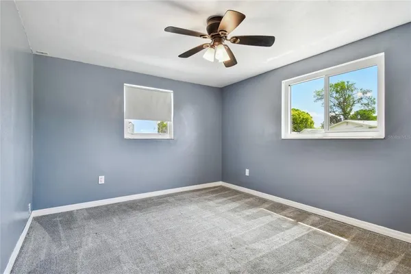 a view of room with a ceiling fan and window