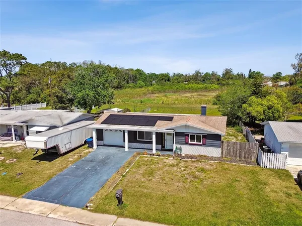 a aerial view of a house with swimming pool and a yard