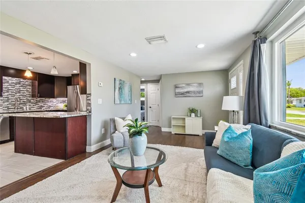 a living room with stainless steel appliances kitchen island granite countertop furniture and a kitchen view