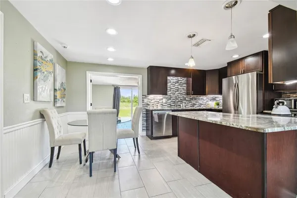 a large kitchen with a table and chairs