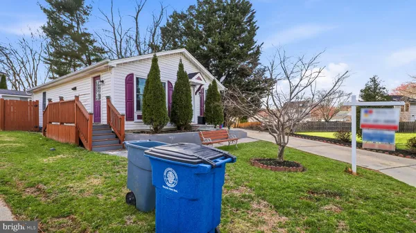 a view of an house with backyard space and a tree