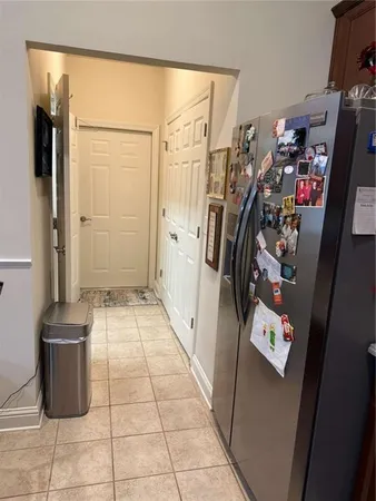 a bedroom with a bed and dresser with chair