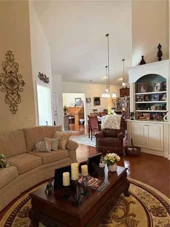 a living room with furniture and a large mirror