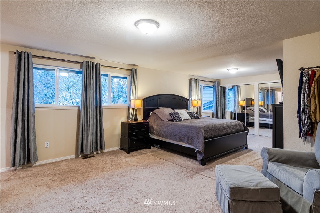 15543 Southeast 169th Street Renton, WA 98058 - Photo 17 of 35 a bedroom with a large bed and a couch