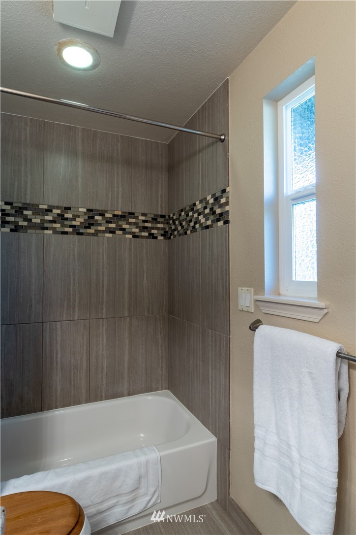 15543 Southeast 169th Street Renton, WA 98058 - Photo 20 of 35 a bathroom with a tub and a shower