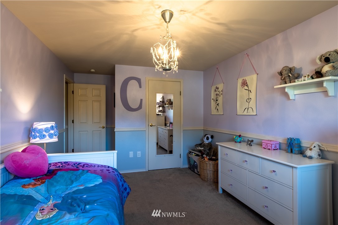 15543 Southeast 169th Street Renton, WA 98058 - Photo 22 of 35 a bedroom with a bed and a chandelier