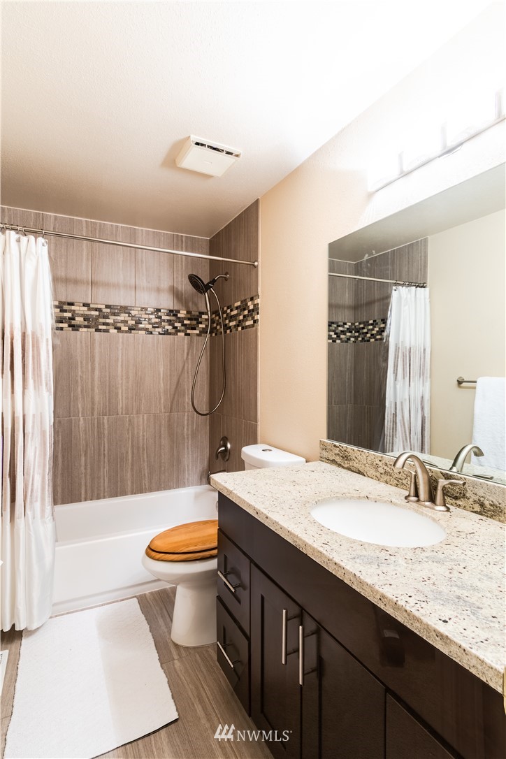 15543 Southeast 169th Street Renton, WA 98058 - Photo 23 of 35 a bathroom with a granite countertop sink toilet and shower