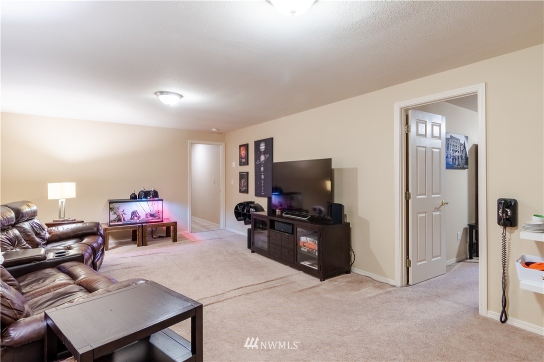 15543 Southeast 169th Street Renton, WA 98058 - Photo 25 of 35 a living room with furniture and a flat screen tv