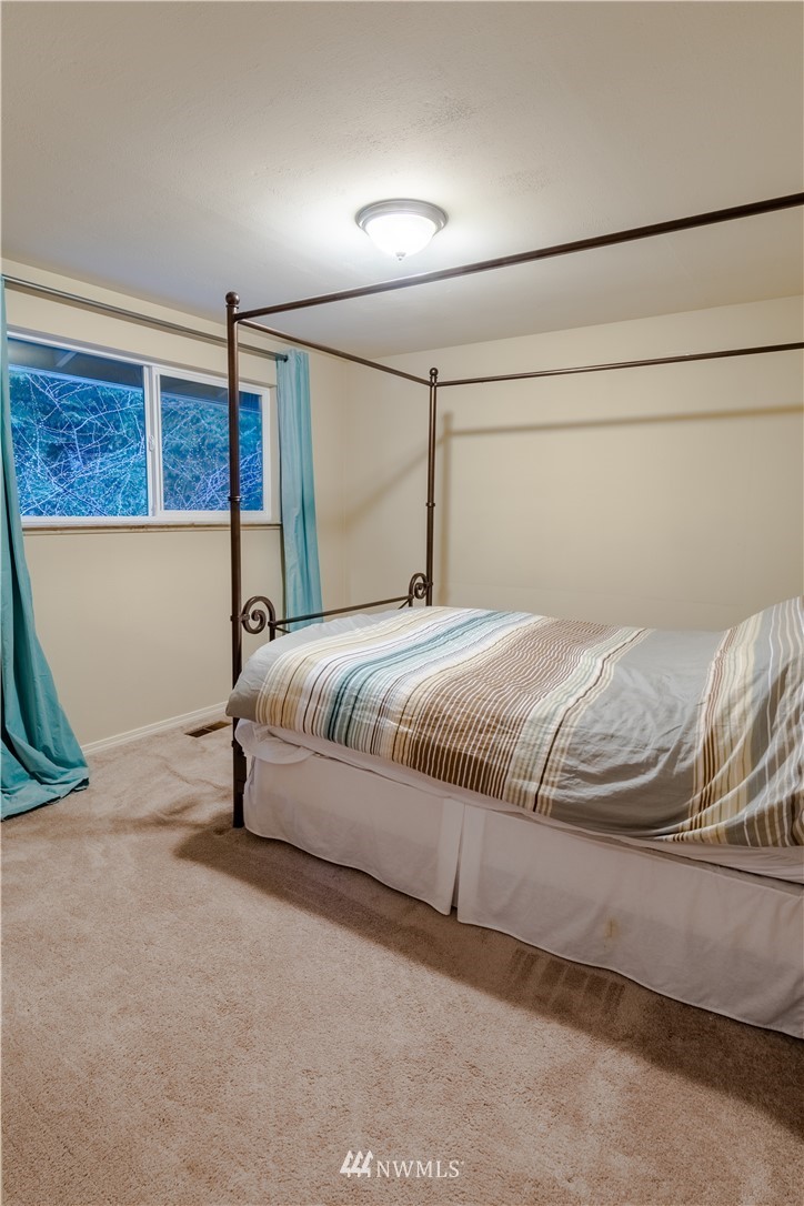 15543 Southeast 169th Street Renton, WA 98058 - Photo 27 of 35 a bedroom with a bed and a ceiling fan