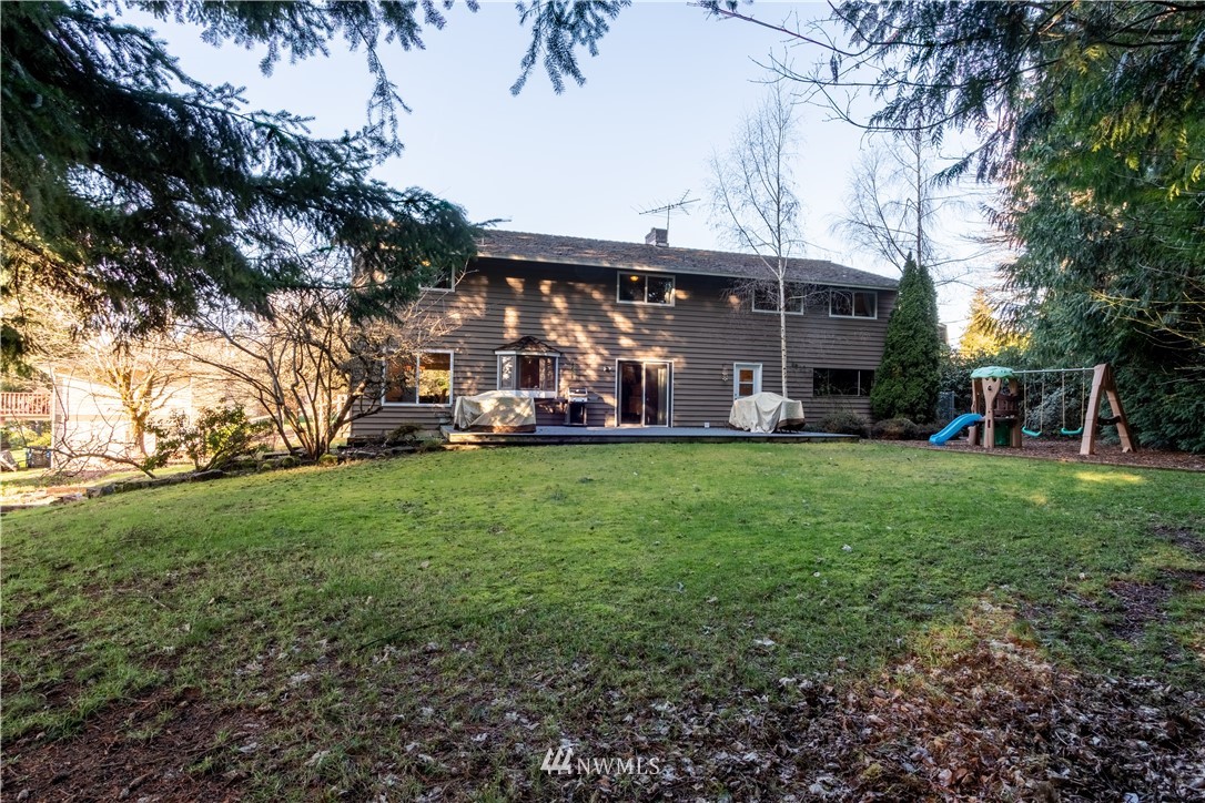 15543 Southeast 169th Street Renton, WA 98058 - Photo 29 of 35 a view of a yard with table and chairs under an umbrella
