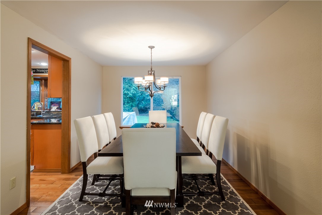 15543 Southeast 169th Street Renton, WA 98058 - Photo 7 of 35 a view of a dining room with furniture window and wooden floor