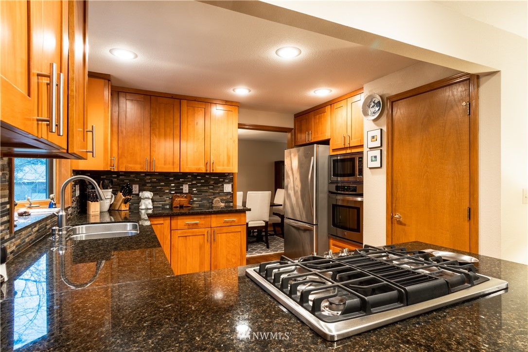 15543 Southeast 169th Street Renton, WA 98058 - Photo 8 of 35 a kitchen with stainless steel appliances granite countertop a stove and a refrigerator