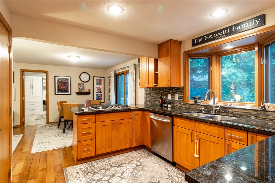 15543 Southeast 169th Street Renton, WA 98058 - Photo 9 of 35 a large kitchen with stainless steel appliances granite countertop a sink and cabinets