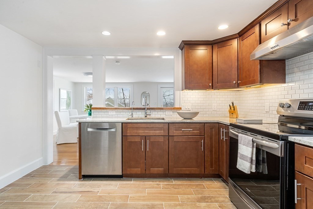 11 Oakencroft Road Wellesley, MA 02482 - Photo 6 of 28 a kitchen with stainless steel appliances granite countertop a sink a stove a refrigerator and a microwave