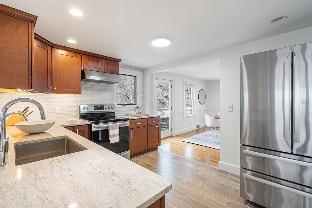 11 Oakencroft Road Wellesley, MA 02482 - Photo 8 of 28 a kitchen with stainless steel appliances granite countertop a refrigerator stove top oven and sink