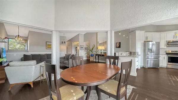 a view of a dining room with furniture and wooden floor