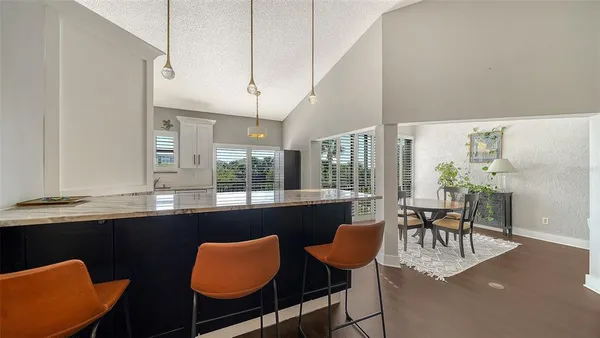 a dining room with wooden floor and a window