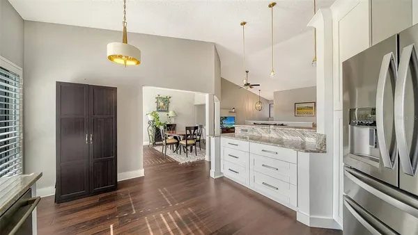 a kitchen with stainless steel appliances granite countertop a refrigerator and a stove top oven