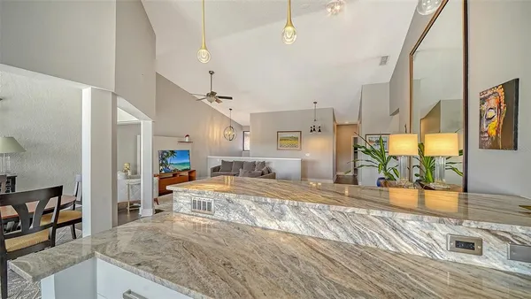 a large room with kitchen view and living room
