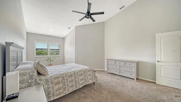 a bedroom with a bed dresser and a window