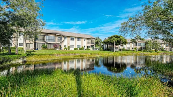 a view of residential house with outdoor space and lake